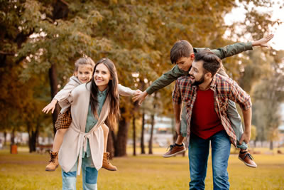 Happy family enjoying autumn outdoors - Savings